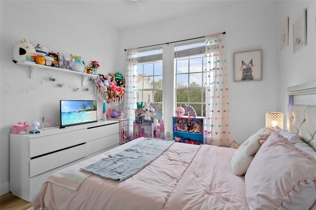 bedroom with hardwood / wood-style flooring