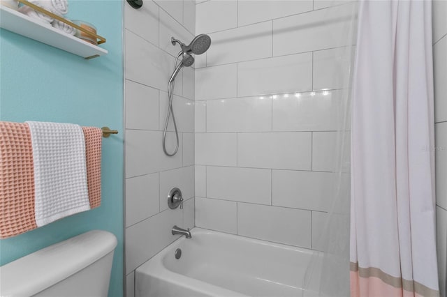 bathroom featuring shower / bath combo and toilet