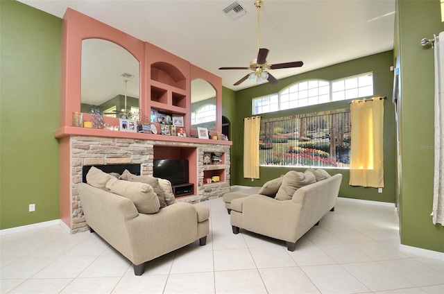 living room featuring ceiling fan, light tile patterned flooring, and a fireplace