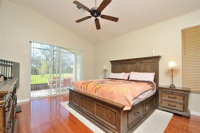 bedroom featuring dark wood-type flooring, ceiling fan, access to exterior, and vaulted ceiling