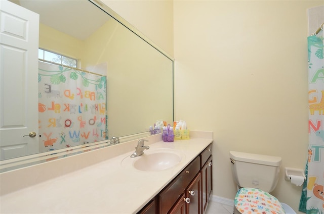 bathroom featuring toilet, vanity, and tile patterned floors