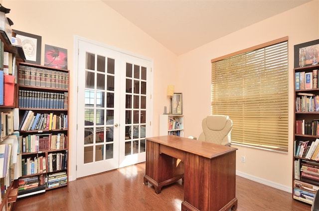 home office with lofted ceiling, french doors, and hardwood / wood-style floors