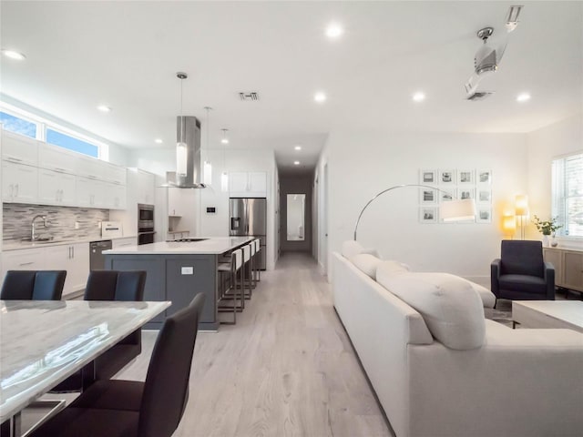 living room with sink and light hardwood / wood-style flooring