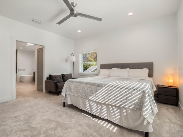 bedroom featuring ceiling fan, light colored carpet, and ensuite bathroom