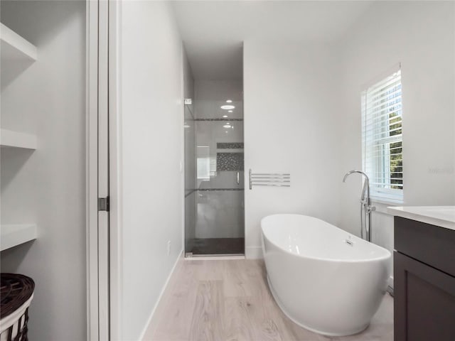 bathroom featuring shower with separate bathtub, wood-type flooring, and vanity