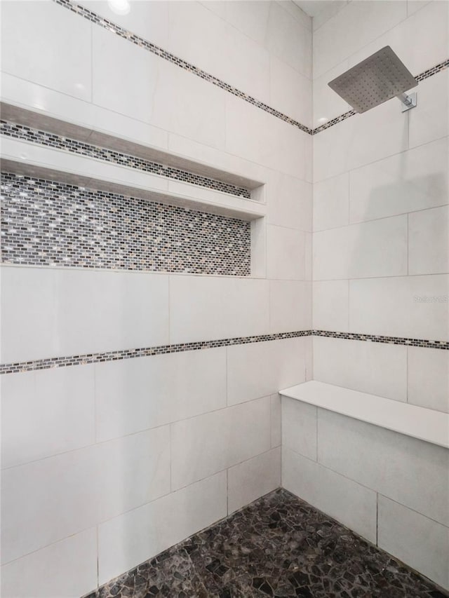 bathroom with tiled shower