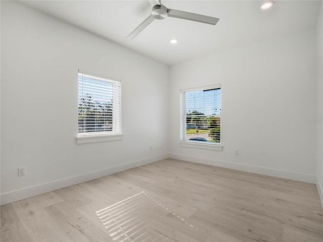 spare room featuring light hardwood / wood-style floors and ceiling fan