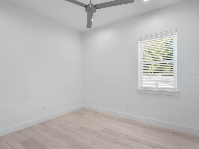 spare room with ceiling fan and light wood-type flooring