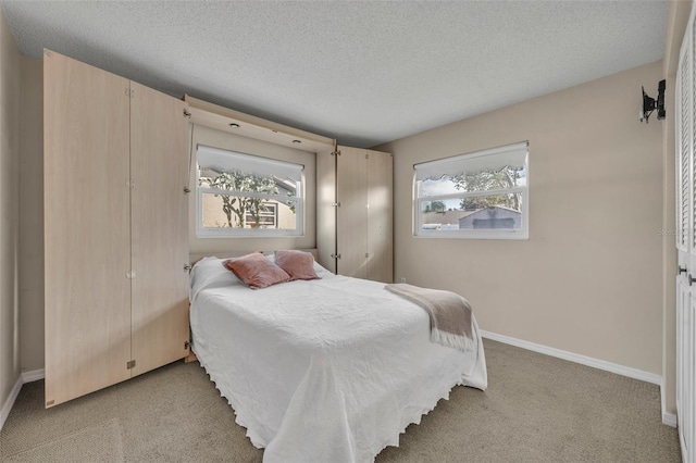 carpeted bedroom featuring a textured ceiling