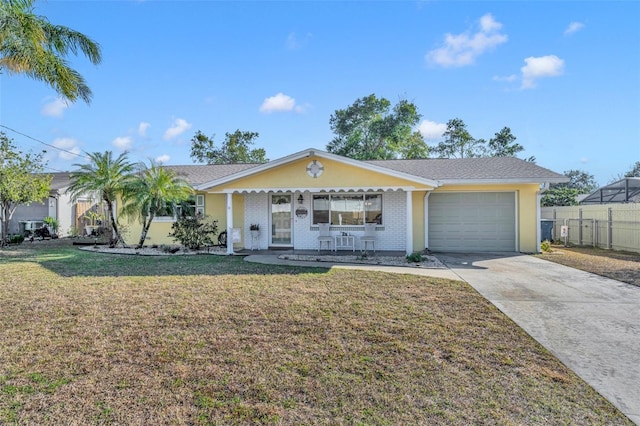 ranch-style home featuring a garage, a front lawn, and covered porch