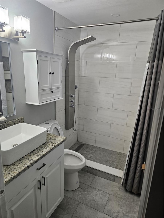 bathroom featuring toilet, a shower with curtain, and vanity