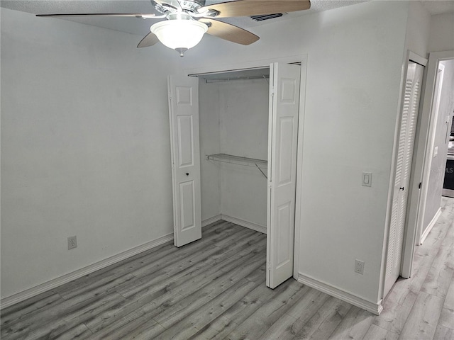 unfurnished bedroom featuring ceiling fan and light wood-type flooring