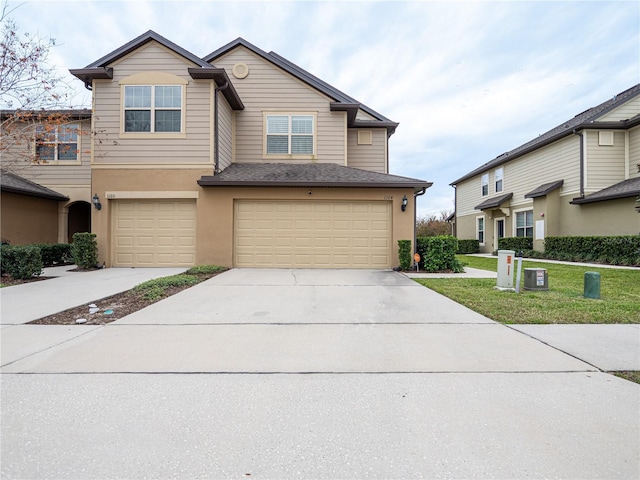 view of front of house with a garage and a front yard