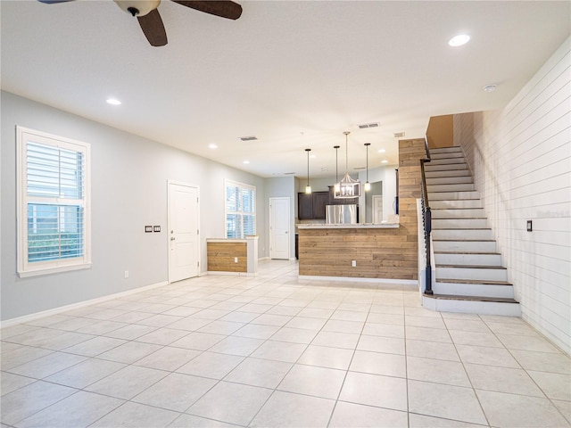 unfurnished living room with ceiling fan and light tile patterned floors