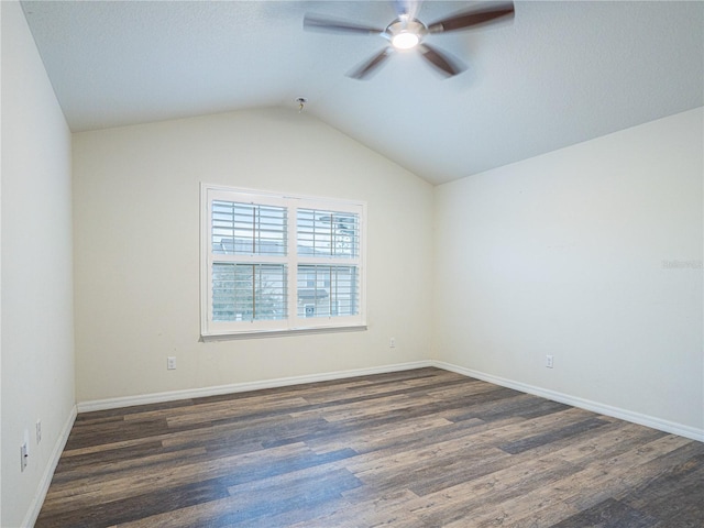 spare room featuring ceiling fan, dark hardwood / wood-style flooring, and vaulted ceiling