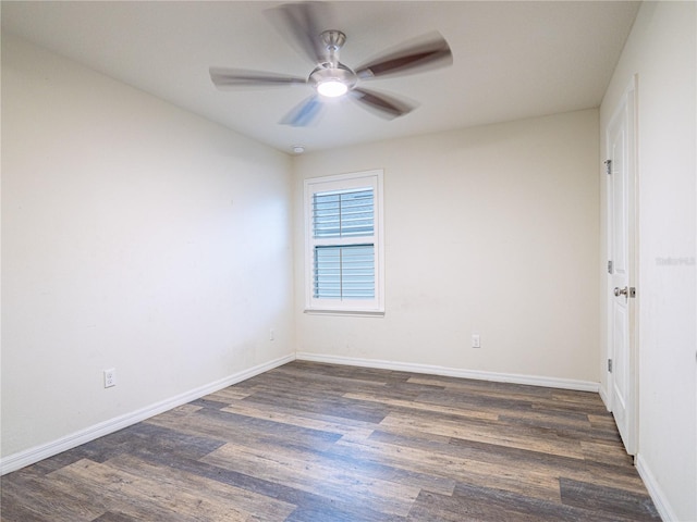 spare room with ceiling fan and dark hardwood / wood-style flooring