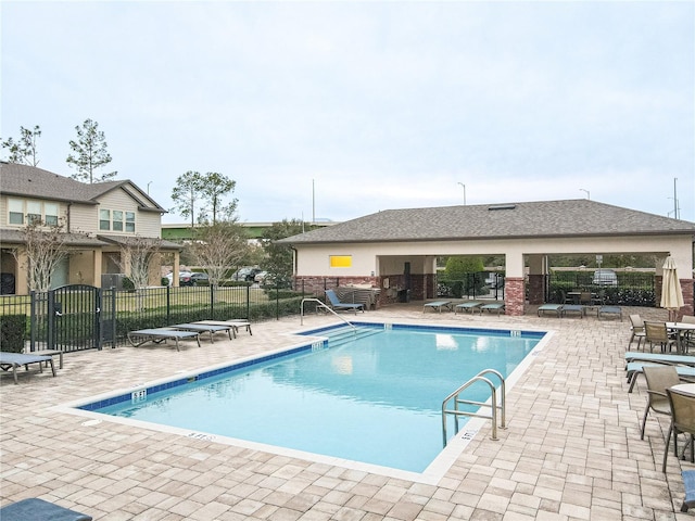 view of swimming pool with a patio area and a pergola