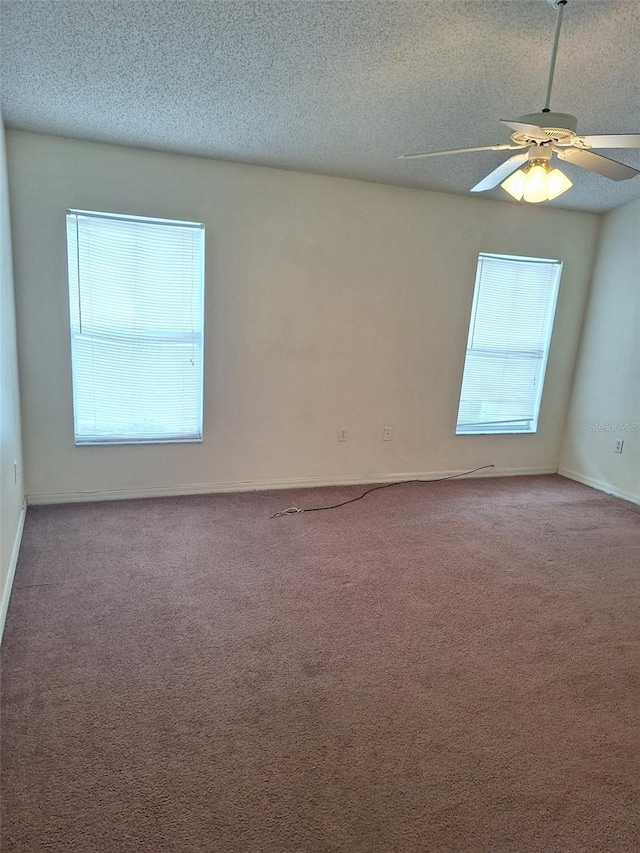 spare room with ceiling fan, a textured ceiling, and carpet flooring