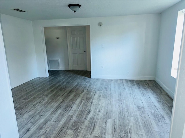 spare room with wood-type flooring