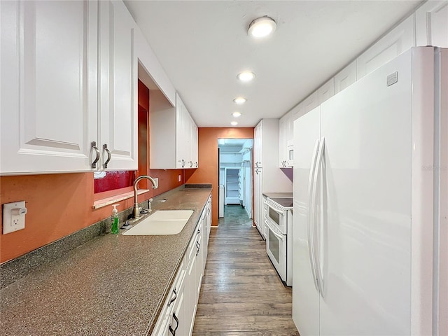 kitchen featuring dark wood-type flooring, white cabinetry, sink, and white appliances