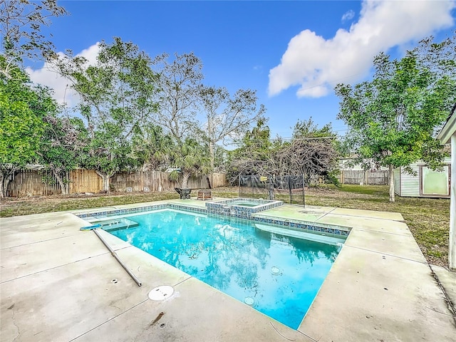 view of swimming pool featuring an in ground hot tub, a patio area, and a diving board