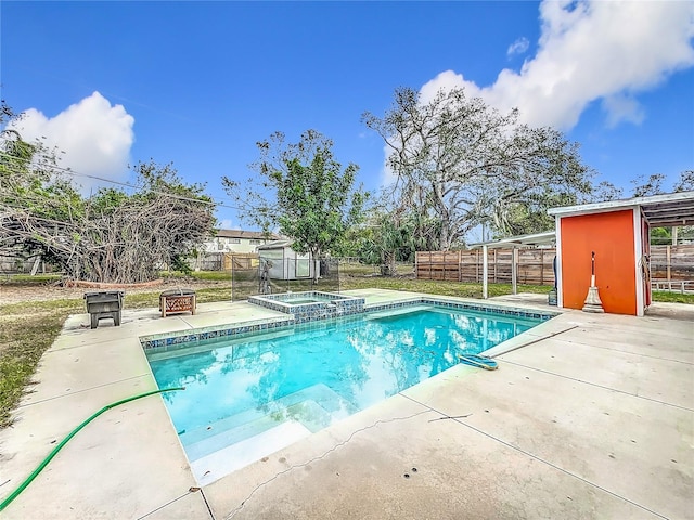 view of pool with a patio and an in ground hot tub