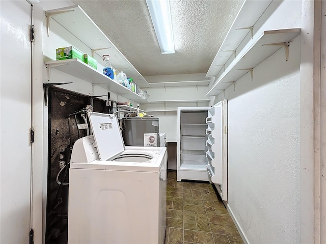 laundry room featuring water heater and separate washer and dryer