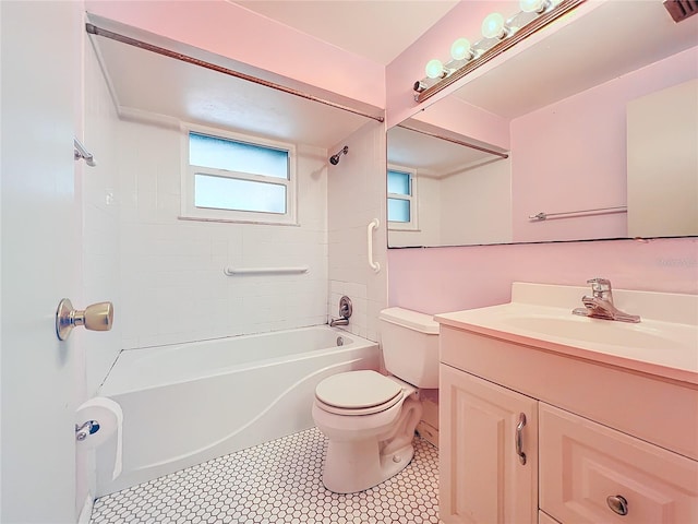 full bathroom with toilet, vanity, and tiled shower / bath combo