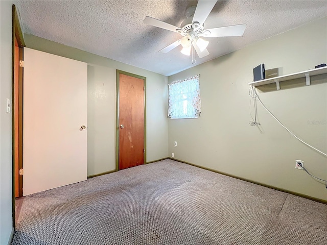 unfurnished bedroom with a textured ceiling, ceiling fan, and carpet flooring