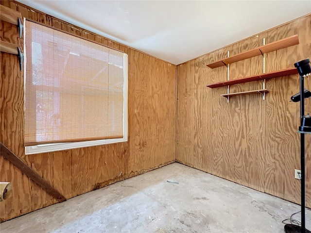 spare room featuring wood walls