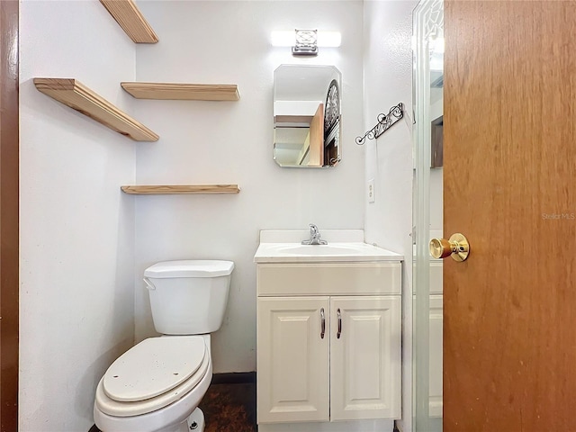 bathroom with toilet and vanity