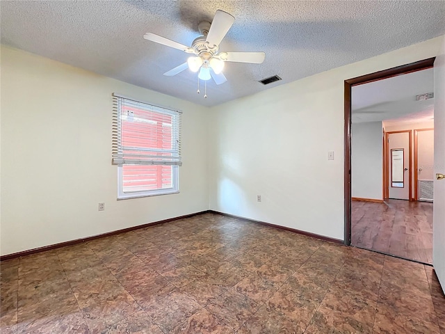 empty room featuring a textured ceiling and ceiling fan