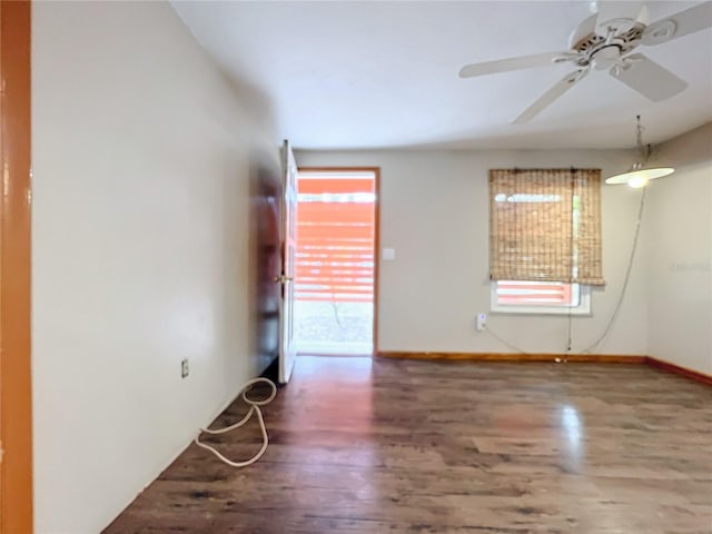 unfurnished room with ceiling fan and dark hardwood / wood-style flooring