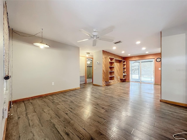 unfurnished living room featuring ceiling fan, wood-type flooring, and built in features