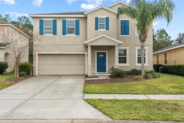 view of front of home featuring a garage and a front lawn