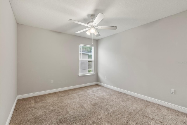 carpeted spare room with ceiling fan