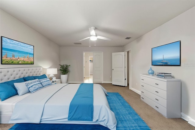 bedroom with ceiling fan and light carpet