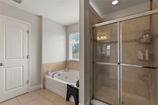 bathroom featuring tile patterned floors, separate shower and tub, and a textured ceiling