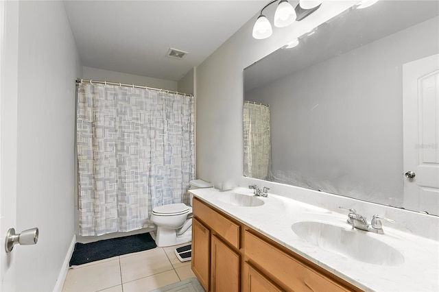 bathroom featuring vanity, toilet, and tile patterned flooring