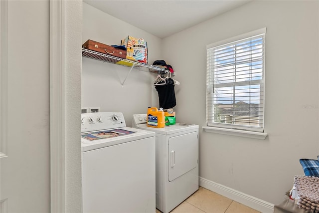 washroom with washing machine and dryer and light tile patterned floors