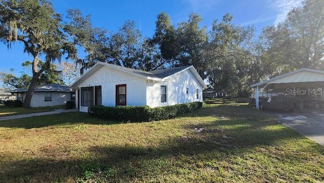 view of side of home with a lawn