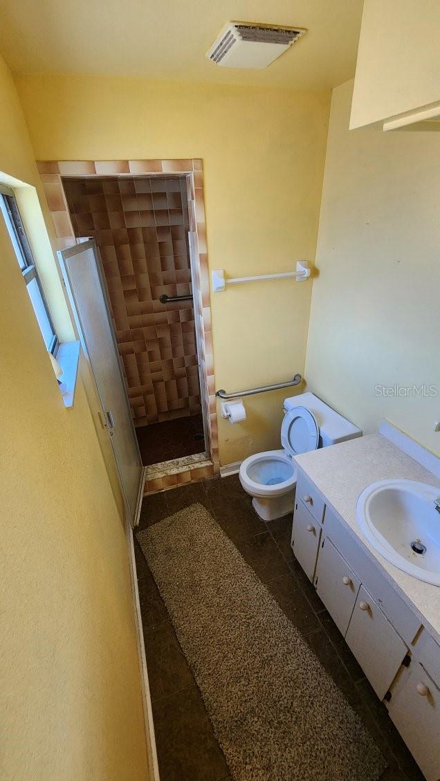 bathroom featuring vanity and toilet