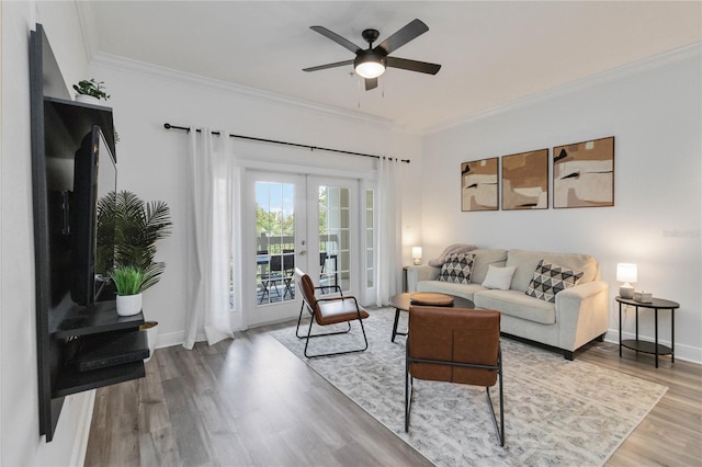 living room featuring hardwood / wood-style flooring, ornamental molding, french doors, and ceiling fan