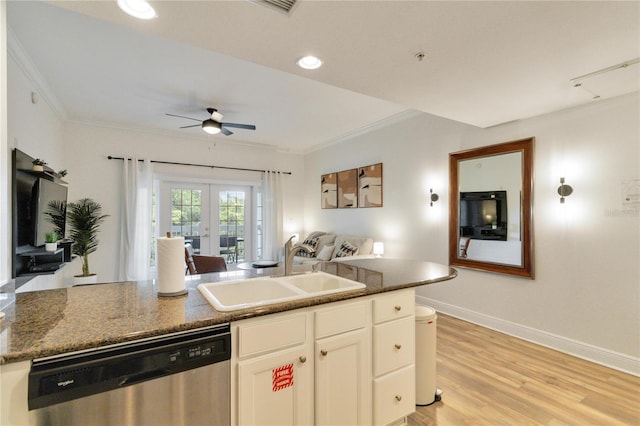 kitchen with dishwasher, sink, white cabinets, and crown molding