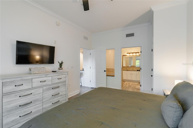 bedroom with ornamental molding, connected bathroom, ceiling fan, and light hardwood / wood-style floors