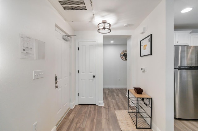 corridor featuring light hardwood / wood-style floors