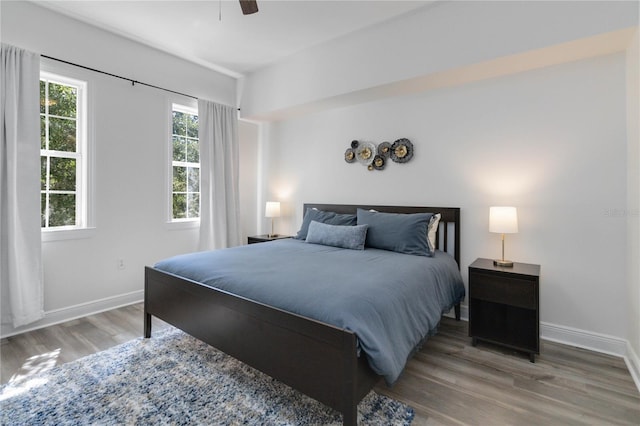 bedroom with wood-type flooring and ceiling fan