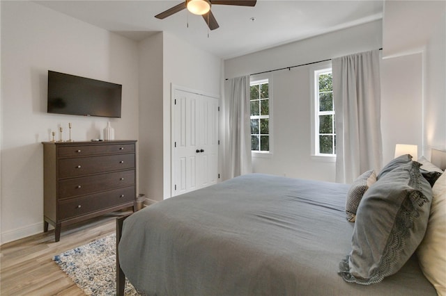 bedroom with ceiling fan, a closet, and light wood-type flooring