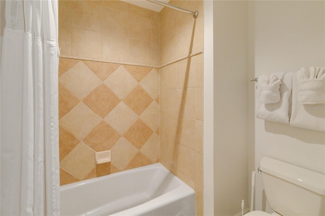 bathroom with shower / tub combo with curtain and toilet