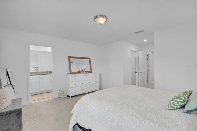 bedroom featuring light colored carpet and connected bathroom